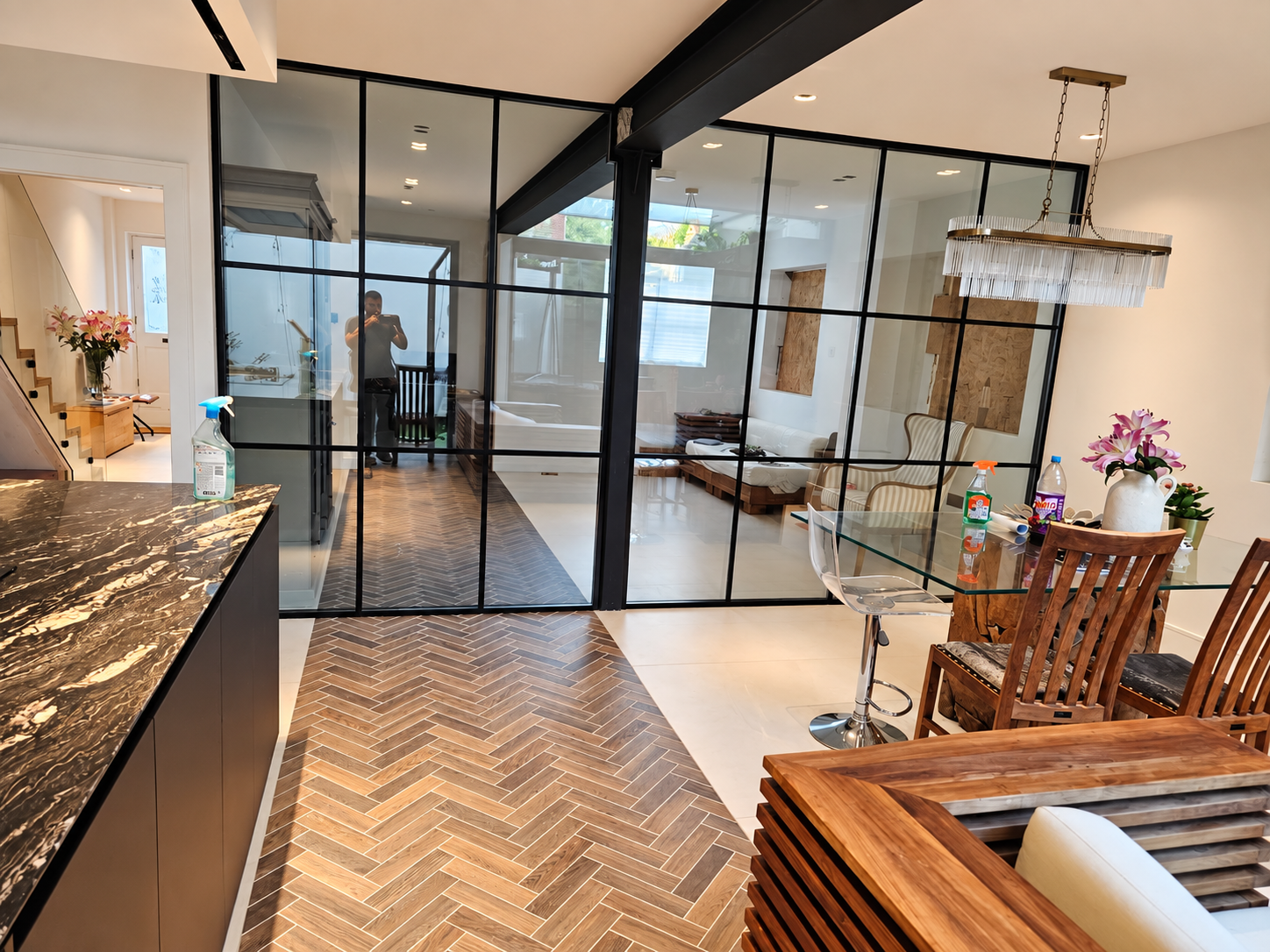 Acoustic laminated and toughened glass partition with black grid framing in Battersea