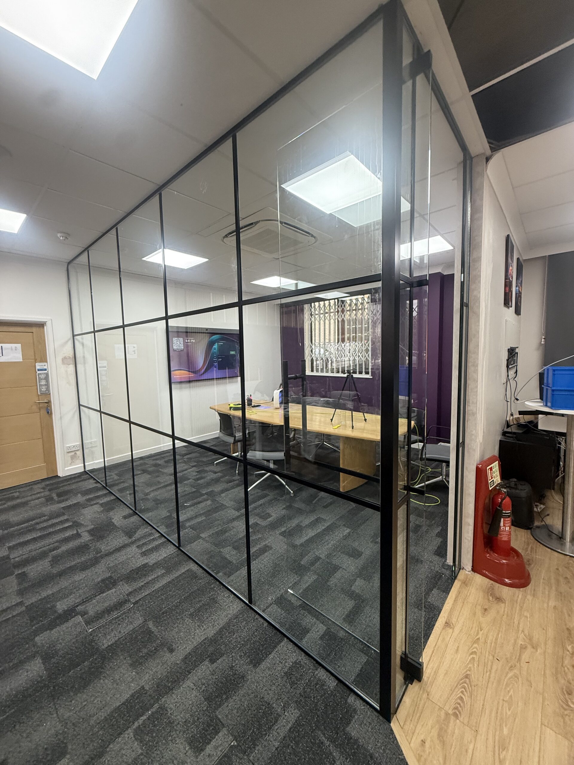 Internal Crittall-style glass partition with black framed glazed door